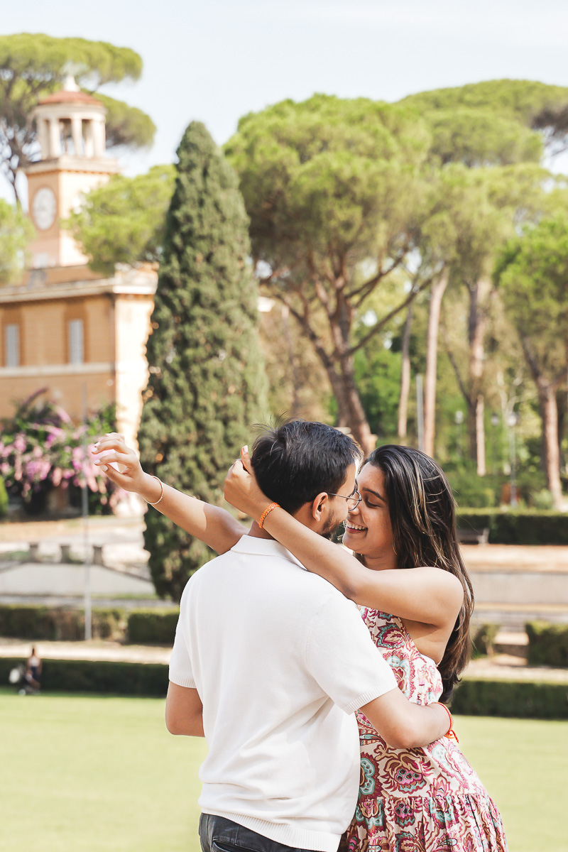 a man and woman hugging at villa borghese