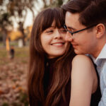 a man and woman hugging and smile at villa borghese - rome